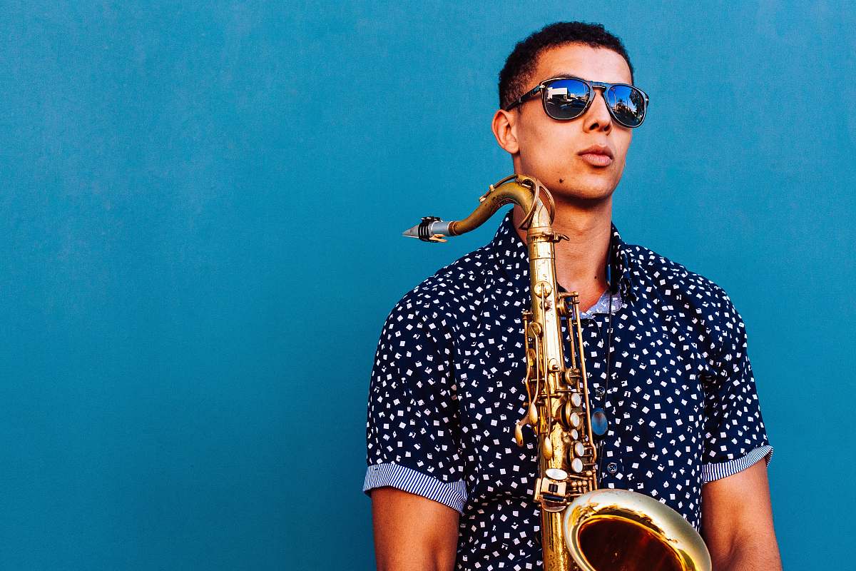 los angeles man holding saxophone instrument blue